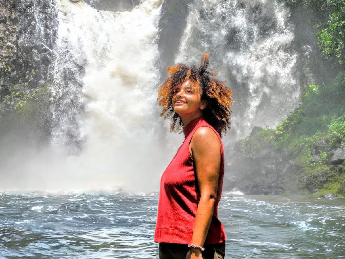 a person standing next to a body of water